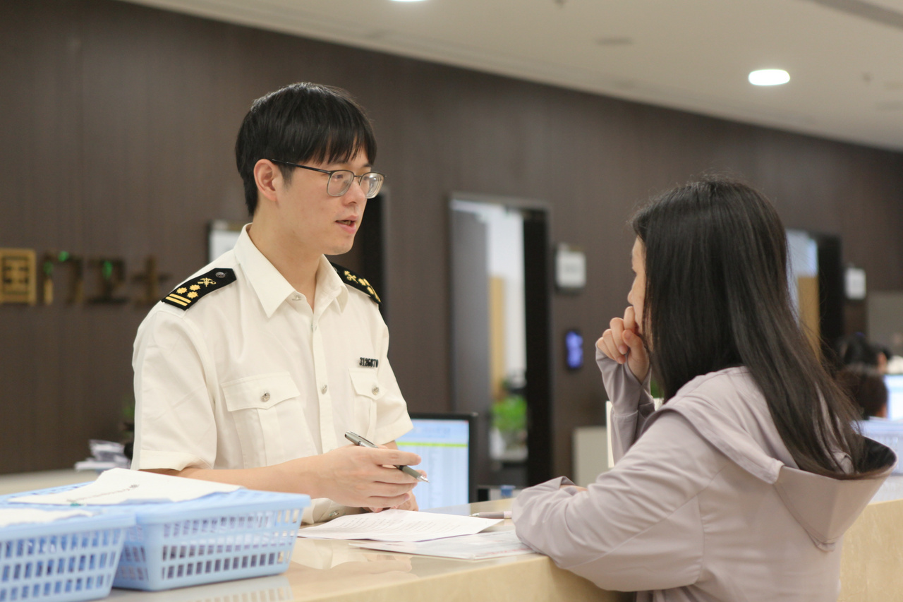 宁波海关关员在业务窗口辅导企业出口东盟申报。傅漪纯摄.jpg